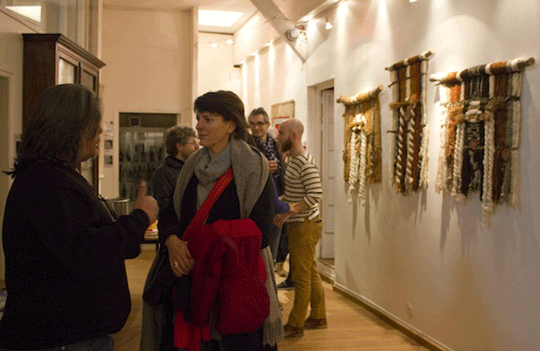 People talking in the gallery amongst the exhibition
