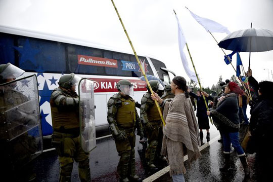 The Peruvian team bus passing Mapuche demonstrators outside the Temuco airport on June 10