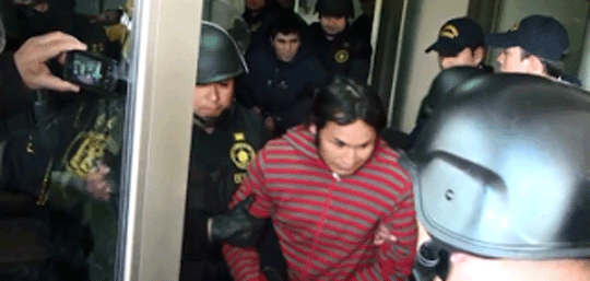 Cristian Levinao Melinao being escorted by police