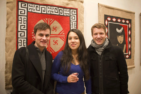 Joy Pentroz in the gallery flanked by two men