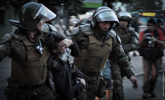 A protestor being arrested by two policemen
