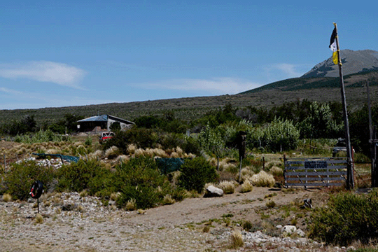 A sign on the fence reads: &lsquo;Santa Rosa community. Recovered Mapuche territory.&rsquo; (Photo: Fabio D&rsquo;Errico)